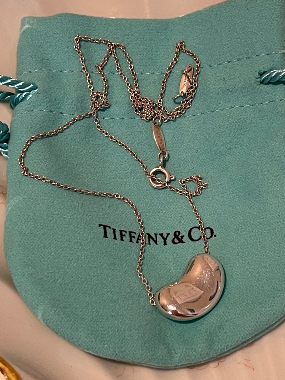 Tiffany & Co. Silver Elsa Peretti Bean Mini Pendant Necklace on Blue Pouch
